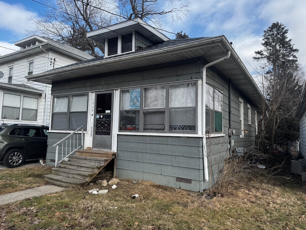 bungalow-style home with entry steps