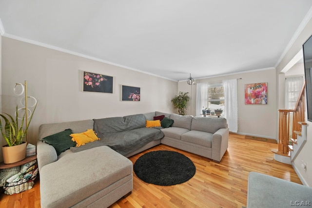 living room with a healthy amount of sunlight, stairs, and light wood-style flooring