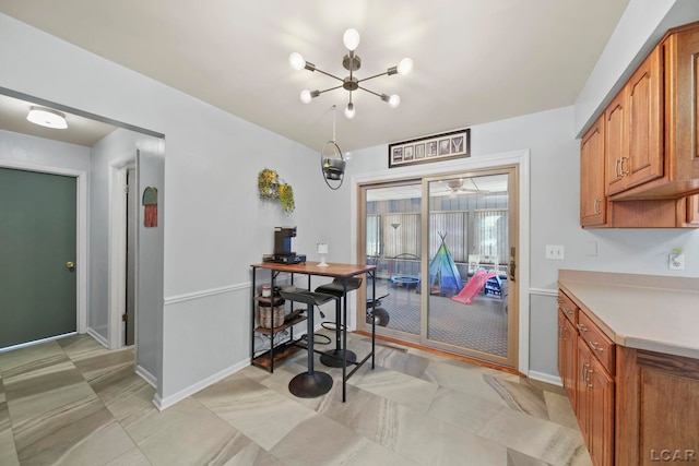 dining area with baseboards and an inviting chandelier