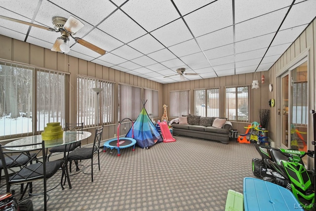 sunroom / solarium with a paneled ceiling and ceiling fan