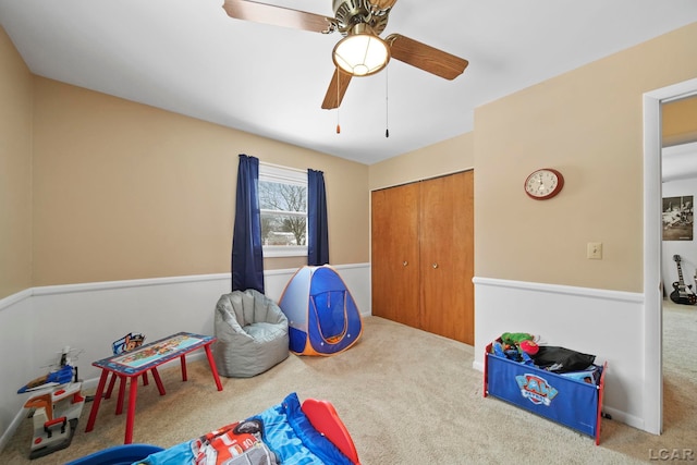 rec room with ceiling fan and carpet