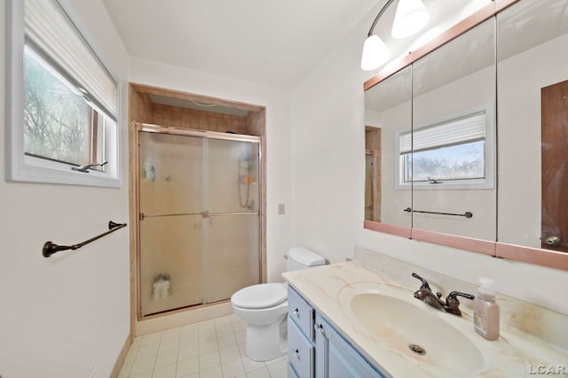 full bath featuring tile patterned flooring, a shower stall, toilet, and vanity