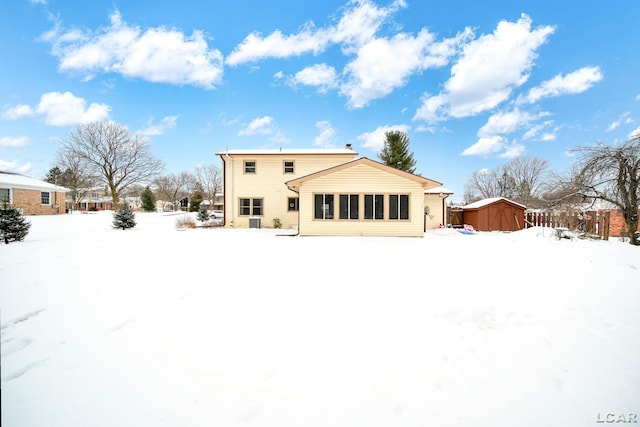 view of snow covered rear of property