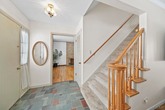 entrance foyer featuring baseboards and stairs