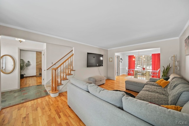 living room with crown molding, stairway, and wood finished floors