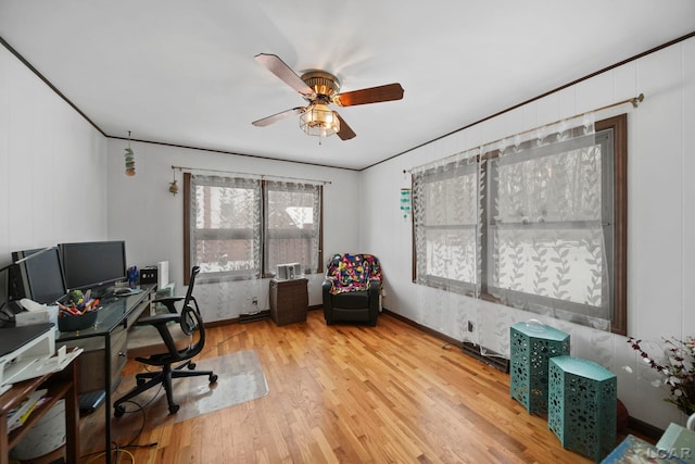 home office featuring ceiling fan, crown molding, and light wood-style floors