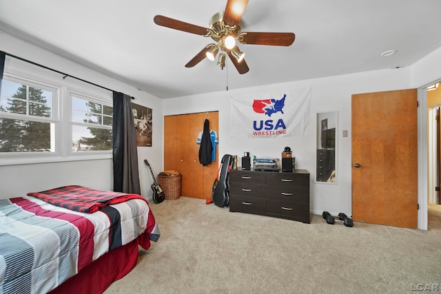 bedroom with a closet, carpet flooring, and ceiling fan