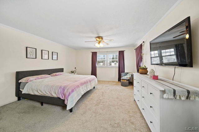 bedroom featuring light carpet, crown molding, and ceiling fan