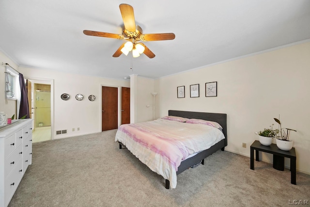 bedroom featuring visible vents, connected bathroom, crown molding, ceiling fan, and light carpet