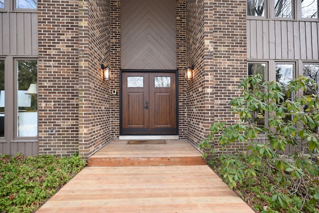 view of exterior entry featuring brick siding