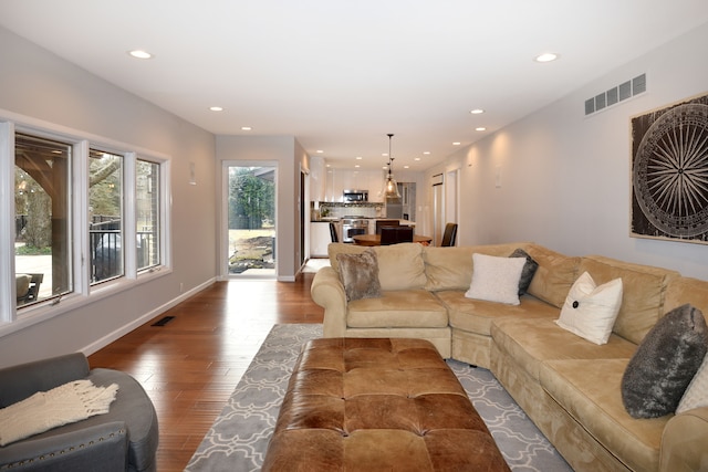 living area with recessed lighting, visible vents, and wood-type flooring