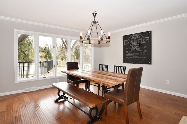 dining area with a chandelier, visible vents, plenty of natural light, and crown molding