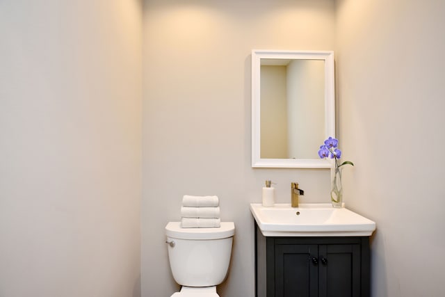 half bathroom with toilet and vanity