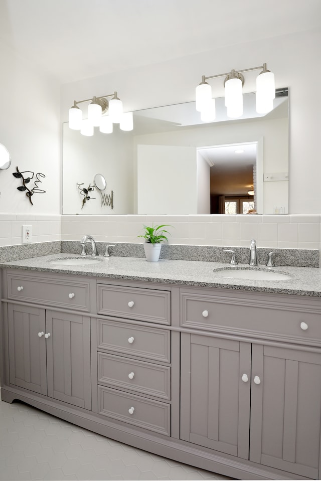 bathroom featuring a sink and double vanity