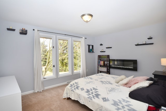 carpeted bedroom featuring baseboards