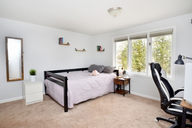 bedroom with carpet flooring and baseboards