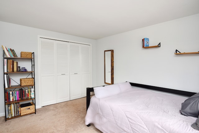 bedroom featuring a closet and light carpet