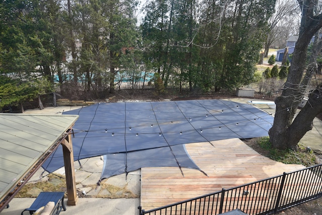 view of pool with a fenced in pool, fence, and a diving board