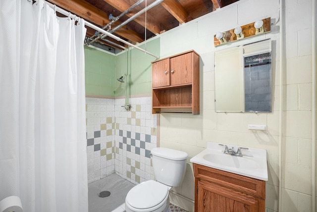 full bath featuring concrete block wall, toilet, a stall shower, and vanity