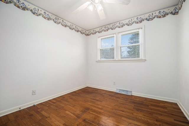 spare room featuring a ceiling fan, hardwood / wood-style flooring, baseboards, and visible vents