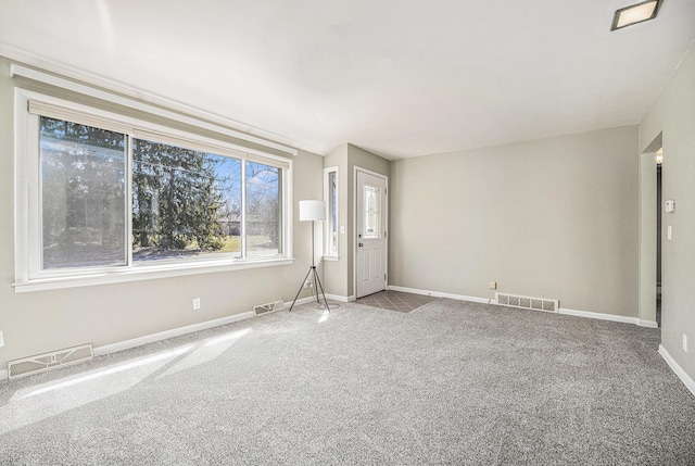 interior space featuring visible vents, baseboards, and carpet floors