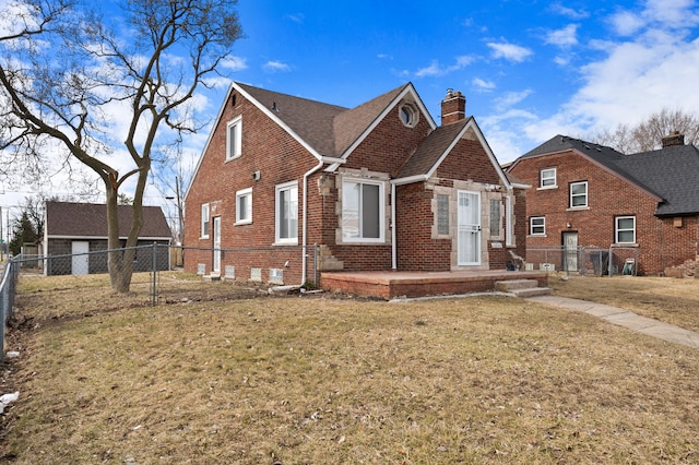 view of front of property with fence, a shingled roof, a chimney, a front lawn, and brick siding