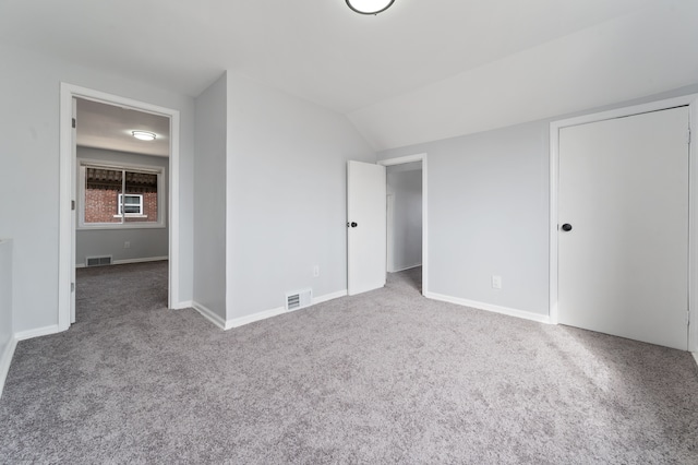 unfurnished bedroom with visible vents, carpet floors, and baseboards