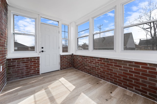 unfurnished sunroom featuring a healthy amount of sunlight