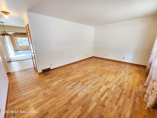 unfurnished room with visible vents, baseboards, and light wood-style flooring