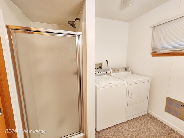 clothes washing area featuring washer and clothes dryer, laundry area, light carpet, and visible vents