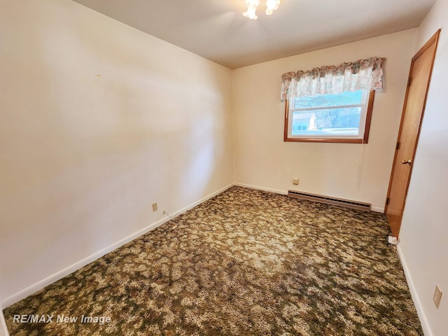 unfurnished bedroom with carpet flooring, a baseboard heating unit, and baseboards