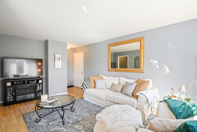 living room with baseboards and wood finished floors