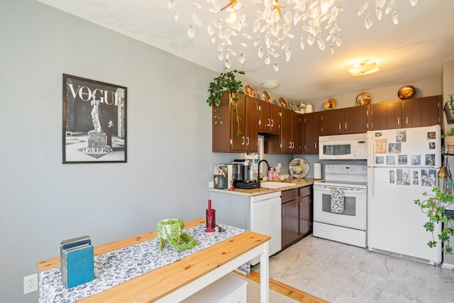 kitchen with light countertops, a notable chandelier, marble finish floor, white appliances, and a sink