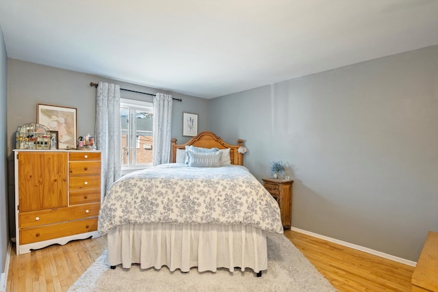 bedroom featuring baseboards and light wood-type flooring