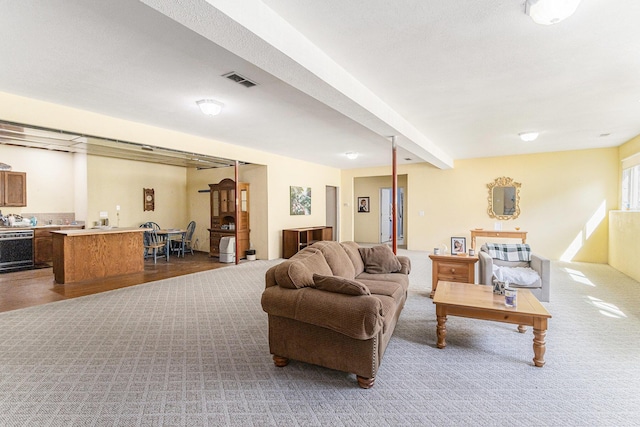 living room with beam ceiling and visible vents