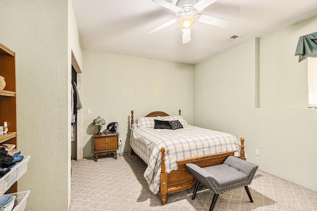 bedroom with carpet, visible vents, and ceiling fan