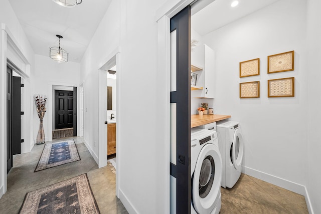 washroom with baseboards and washer and clothes dryer