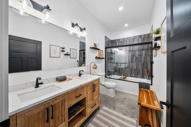 bathroom with enclosed tub / shower combo, double vanity, toilet, and a sink