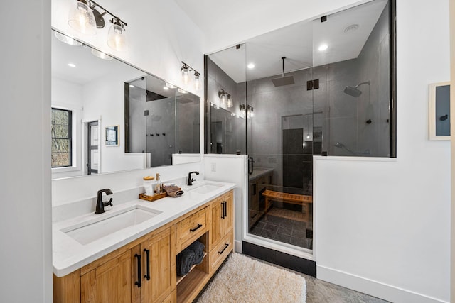 full bath featuring double vanity, a stall shower, and a sink