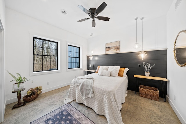 bedroom with baseboards, visible vents, and ceiling fan