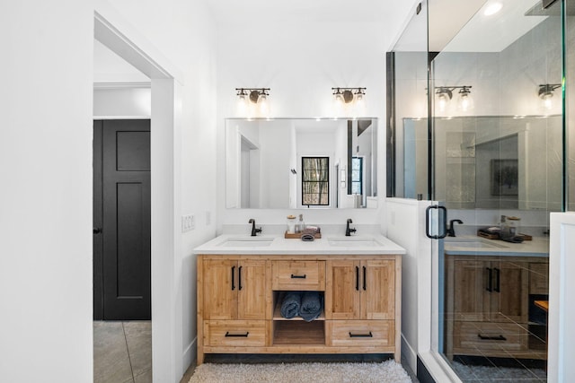 bathroom with a sink, double vanity, and a shower stall