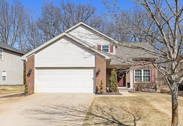 traditional-style home featuring concrete driveway, an attached garage, brick siding, and a front yard