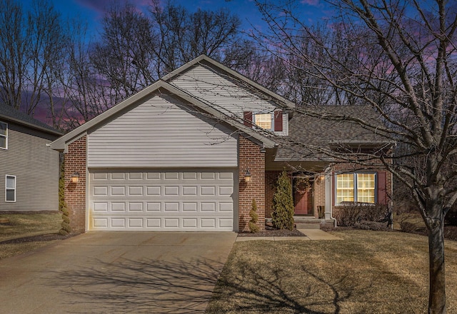 traditional-style house with a garage, brick siding, a yard, and driveway