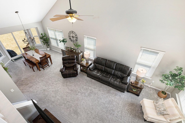 carpeted living room featuring a ceiling fan, baseboards, and high vaulted ceiling