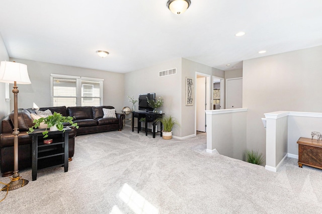 living room featuring recessed lighting, visible vents, baseboards, and light colored carpet