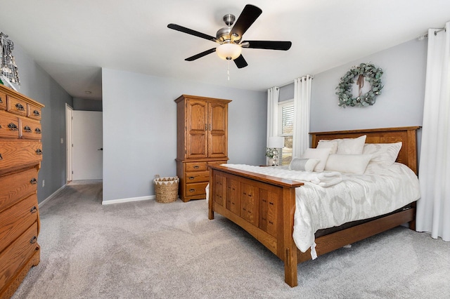 bedroom with light colored carpet, baseboards, and ceiling fan