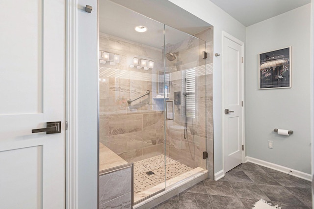 full bathroom featuring baseboards and a stall shower