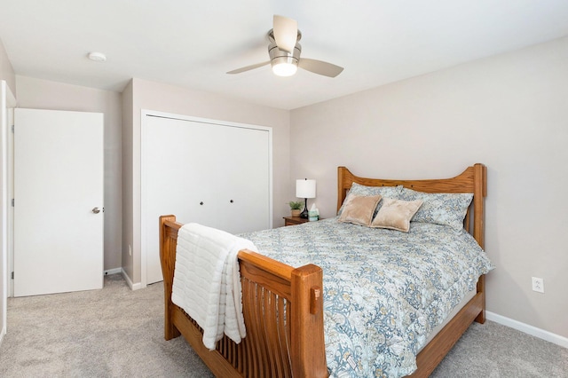 bedroom featuring baseboards, carpet floors, a closet, and ceiling fan