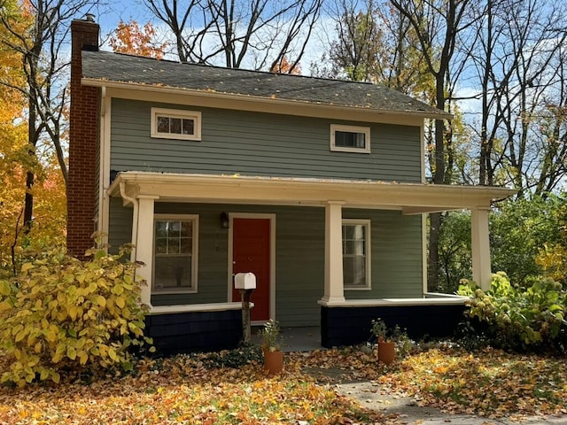 view of front of property featuring a porch and a chimney