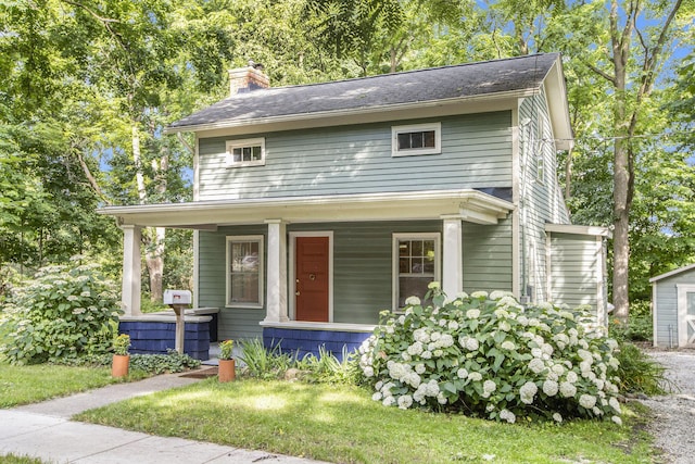 view of front of home with a porch and a chimney